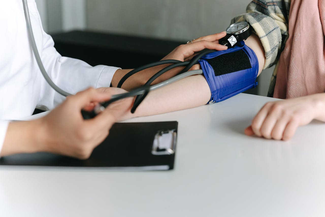 A Healthcare Worker Measuring a Patients Blood Pressure Using a Sphygmomanometer